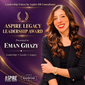 Award banner for the Aspire Legacy Leadership Award; presented to Eman Ghazy, with a smiling woman in a black blazer on a purple-gold background and logos at the bottom.